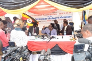 The Uganda Ministry of Health Permanent Secretary (Centre with hands up), Dr Diana Atwiine, talks to the press on a special day organized specifically to celebrate achievement of International Accreditation for the national EID/Viral Load Laboratory at CPHL in Butabika. [Photo: Poni Augustina, CPHL]